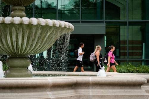 fountain and students walking